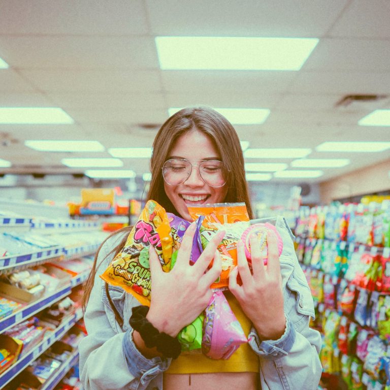 girl with hands full in grocery store